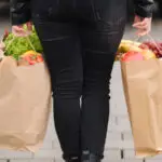 carrying an eco package full of groceries