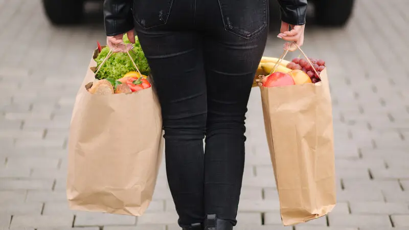 carrying an eco package full of groceries