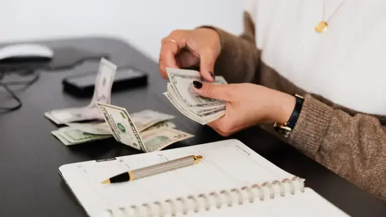 counting money behind desk